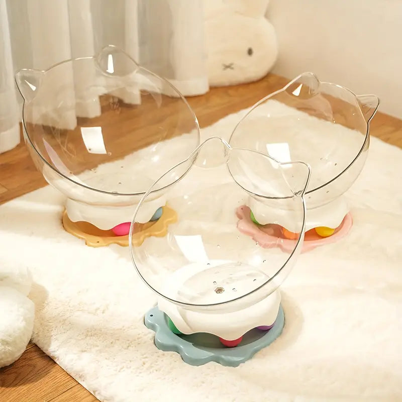 Three acrylic capsule-shaped cat bowls, which is placed on a white surface with a track ball inside it.