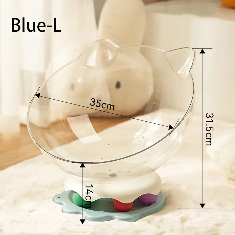 A large blue acrylic capsule-shaped cat bowl, with a track ball which is placed on a white rug