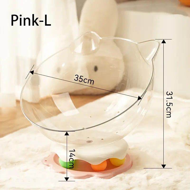 A large pink acrylic capsule-shaped cat bowl, with a track ball which is placed on a white rug