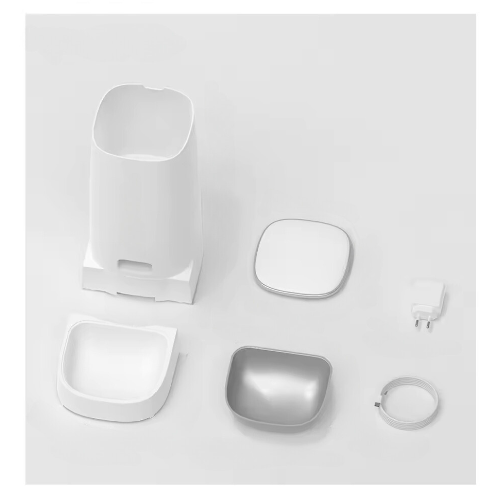 Parts of the white automatic cat feeder, including a stainless steel food bowl and cords.