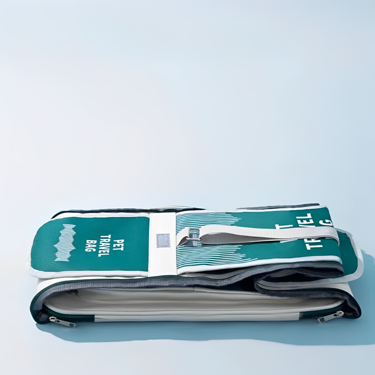 A pet carrier bag with breathable mesh panels in green color with a light blue background and collapsed.