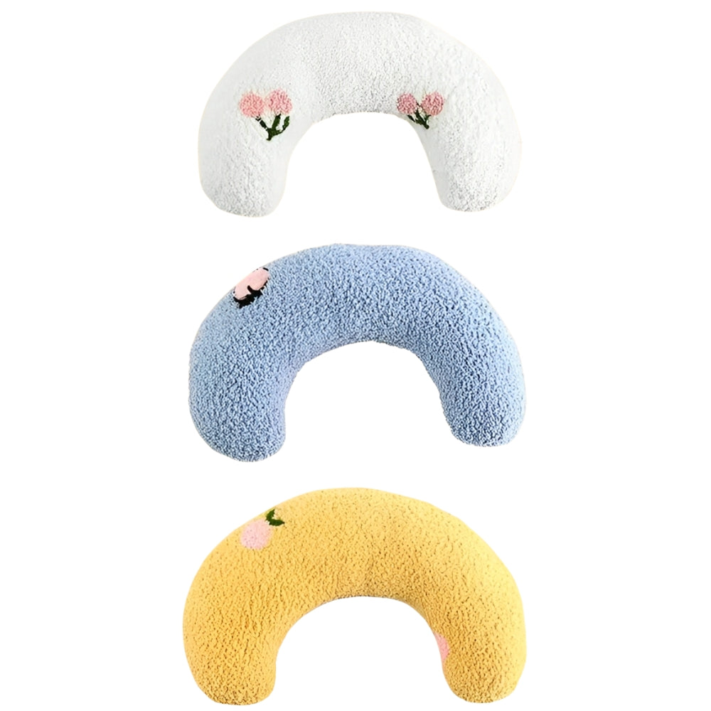 Three colorful U-shaped pillows with floral designs on a white background