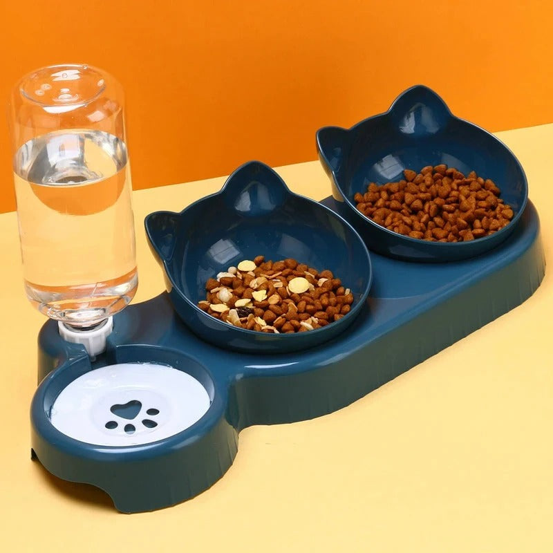 Pet feeding station with two bowls and a glass of water on an orange and yellow background