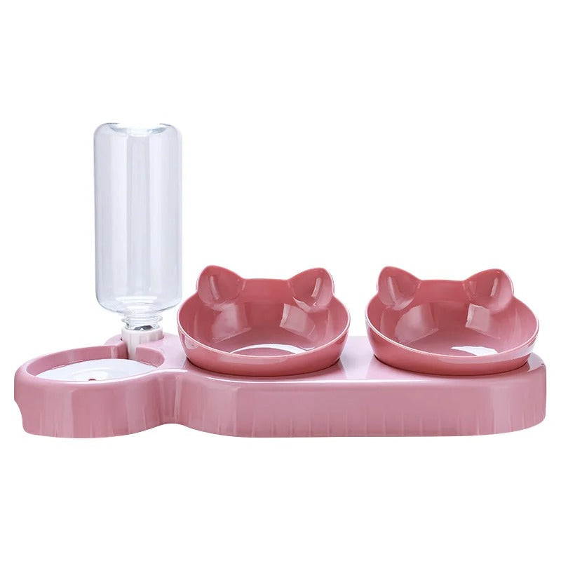 Pink pet feeder with two bowls and a water dispenser on a white background