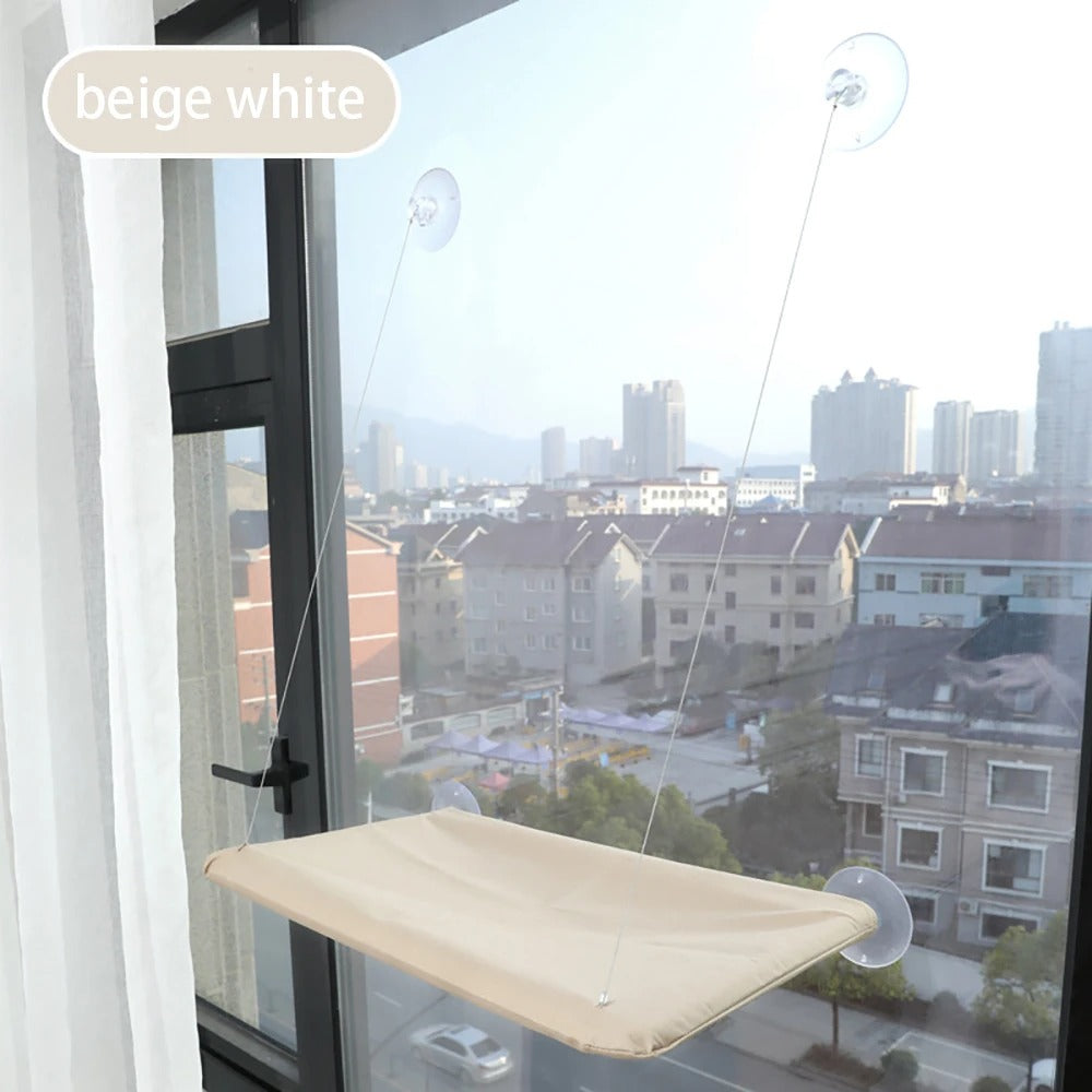 Window-mounted beige white pet seat with suction cups on a clear day.