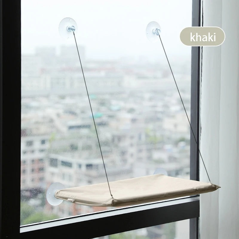 Window-mounted pet perch with suction cups against a cityscape background