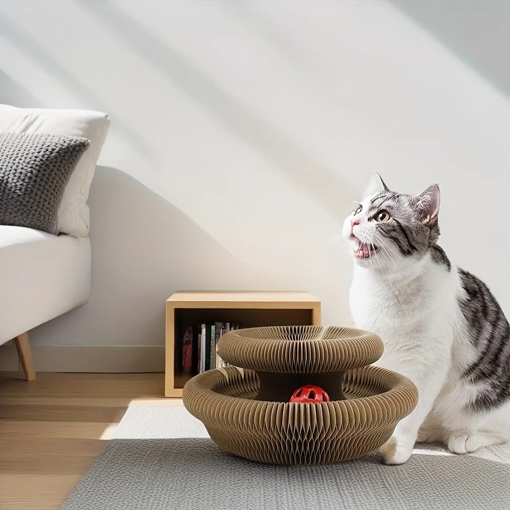 Cat sitting next to a two-tiered cat toy in a modern living room.