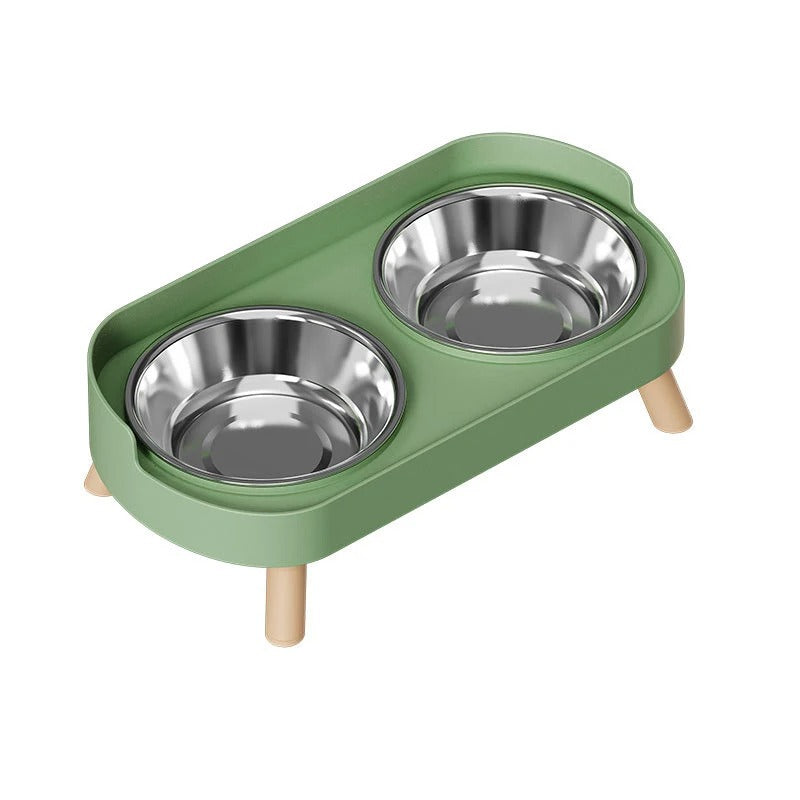 Green cat feeder with two stainless steel bowls on a white background