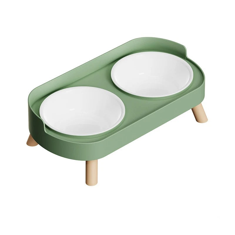Green cat feeder with two white bowls on a white background