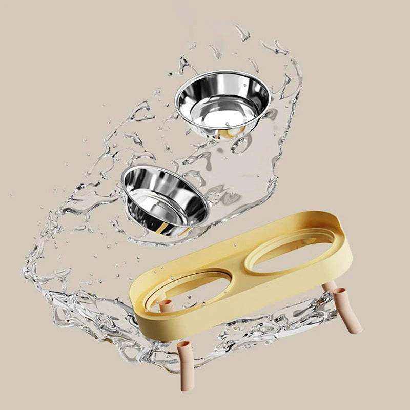 Two stainless steel bowls on a beige background with water splashes
