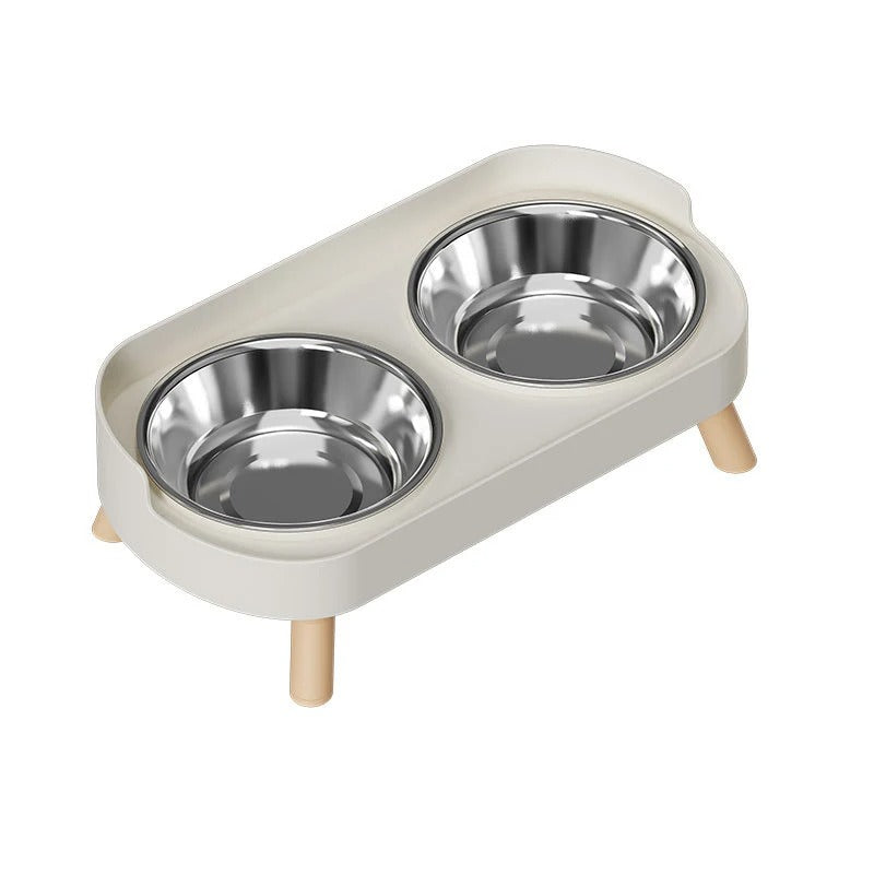 Cat feeding station with two stainless steel bowls on a white background