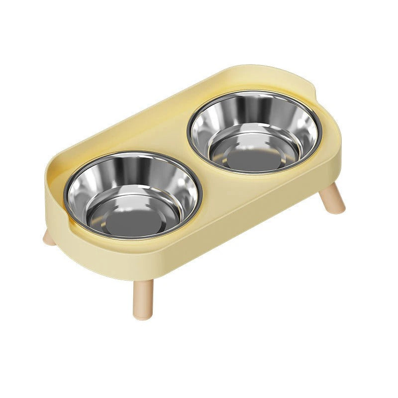 Yellow cat feeder with two stainless steel bowls on a white background