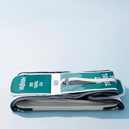 A pet carrier bag with breathable mesh panels in green color with a light blue background and collapsed. 
