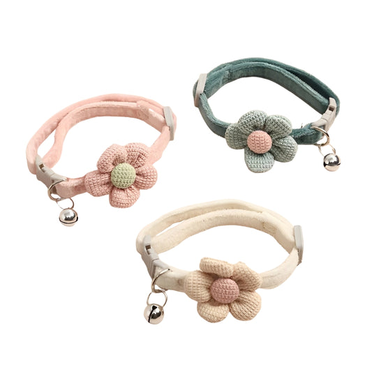 Three handmade crochet cat collars in pink, blue, and beige, each featuring a floral design with a buckle for adjustability on a white background.