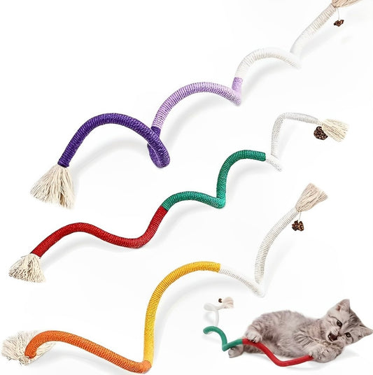 A series of colorful cotton rope cat toys laid out in a row with a grey cat sitting on one of the ropes.