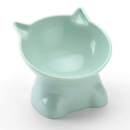 A green plastic cat food bowl with an elevated structure and a protective rim.