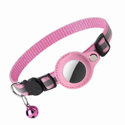 Pink cat collar with silver reflective stripe, a bell, a cat face shaped buckle and airtag holder attached to it.