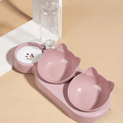 Pink pet bowl set with two bowls and a water bottle on a beige background