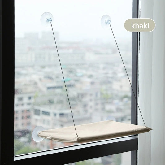 Window-mounted pet perch with suction cups against a cityscape background