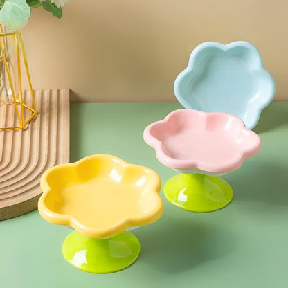 A set of flower ceramic cat bowls (3) with a raised design in yellow, pink and blue colours.