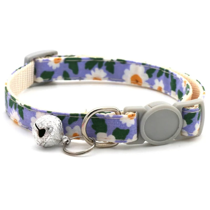 Floral patterned dog collar with a bell and detachable tag on a white background