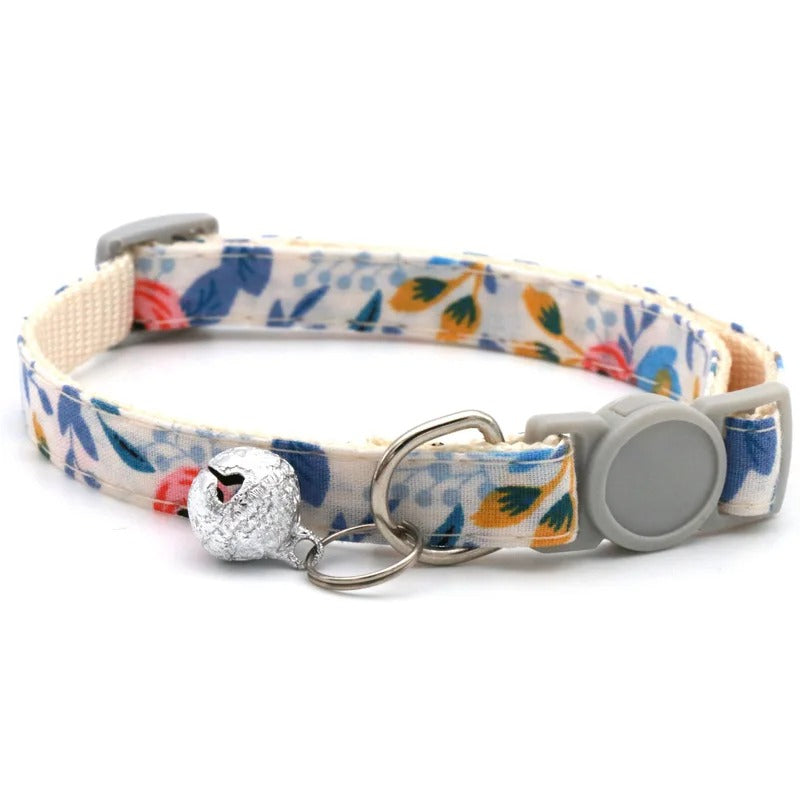 Floral patterned dog collar with a decorative charm on a white background