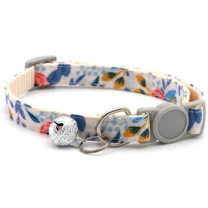 Floral patterned dog collar with a decorative charm on a white background