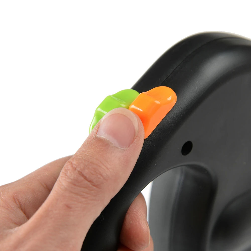 Hand holding a black leash with green and orange buttons on a white background