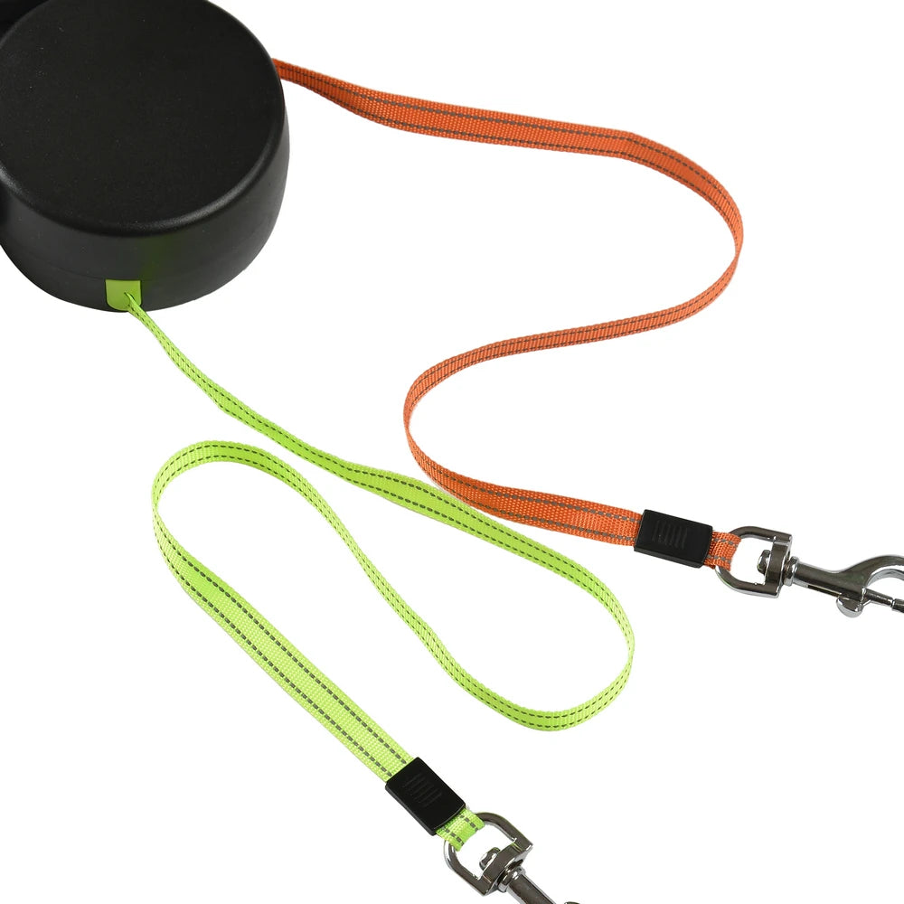 Dog leashes in green and orange with black reel on a white background
