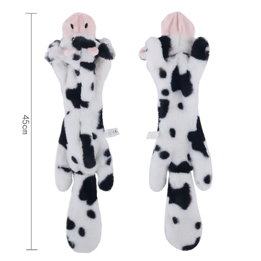 Two cow-shaped plush toys with measurement label on a white background
