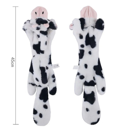 Two cow-shaped plush toys with measurement label on a white background