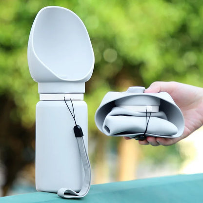 Collapsible white travel spoon set with carrying case against a blurred green outdoor background