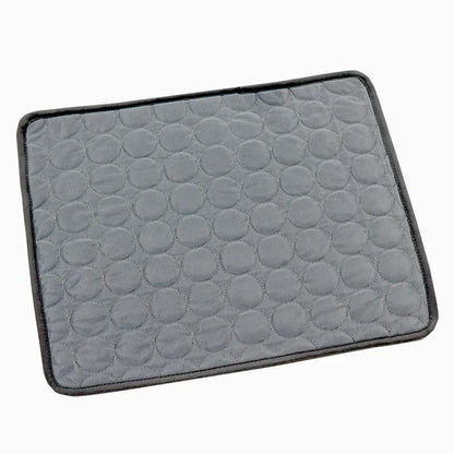 Dark grey cooling mat in a white background