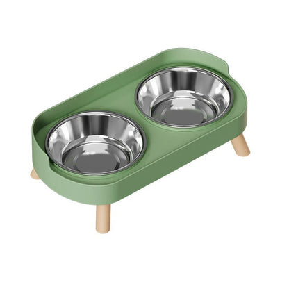 Green cat feeder with two stainless steel bowls on a white background