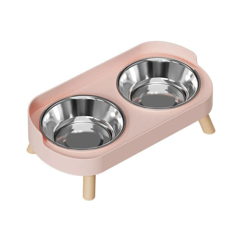 Pink cat feeder with two stainless steel bowls on a white background