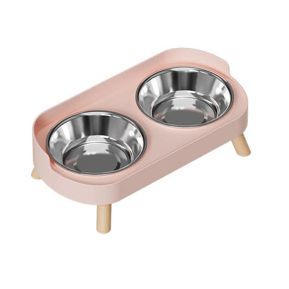 Pink cat feeder with two stainless steel bowls on a white background