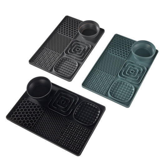 Set of three black and green rubber mats with cup holders on a white background