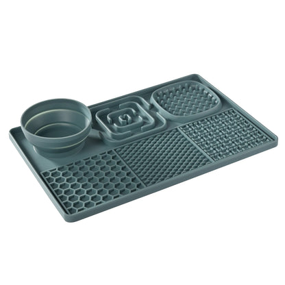 Gray silicone mat with pet bowls on a white background