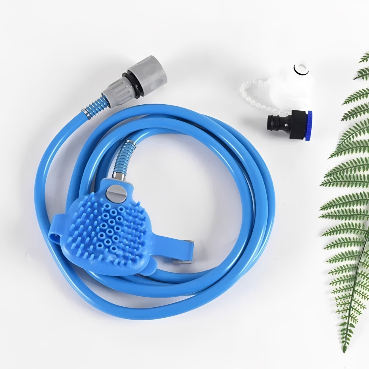 Blue garden hose with spray nozzle on a white background