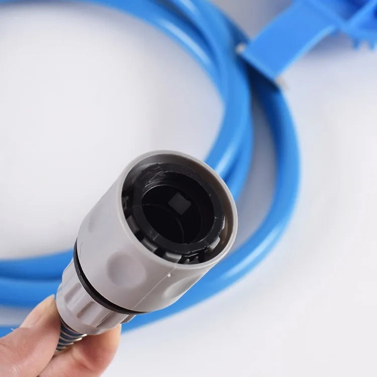 Close-up of a white garden hose nozzle held by a hand with a blue garden hose in the background.