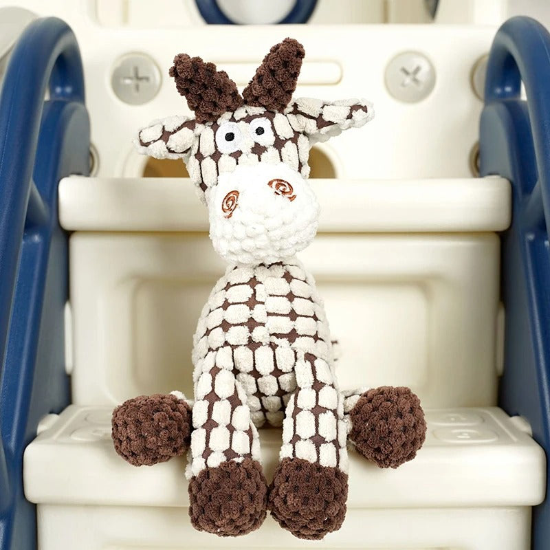 Crocheted deer toy on a child's slide
