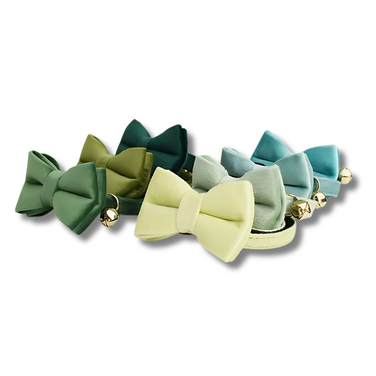 Set of colorful bow-shaped cat collar on a white background