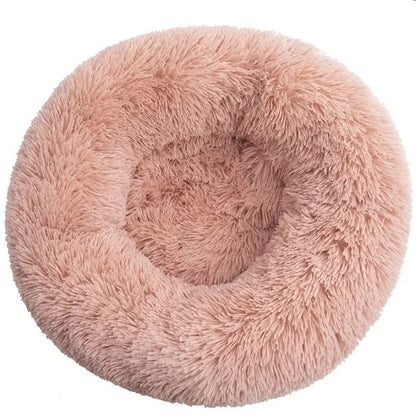 A salmon plush round bed with a white background