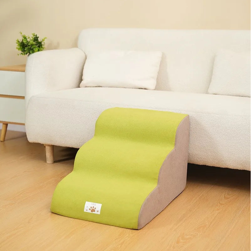Green pet ramp in front of a white sofa with a neutral background