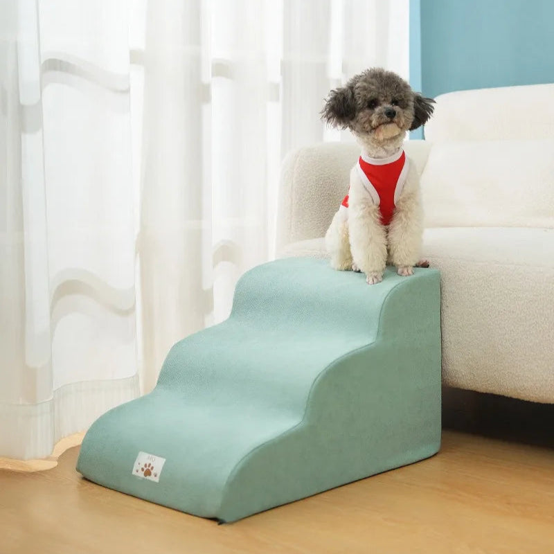 Pet step leading up to a white couch with a dog on top, against a light-colored wall.